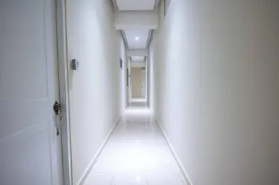 a hallway with white walls and a white floor at Suite 10 en la Zona Colonial in Santo Domingo