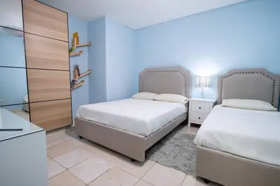 a bedroom with two beds and a dresser at Suite 10 en la Zona Colonial in Santo Domingo
