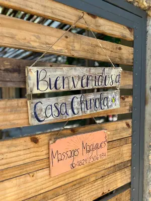 a sign for the entrance to a c salsa chicas restaurant at Casita Chinola - Playa El Encuentro in Bombita