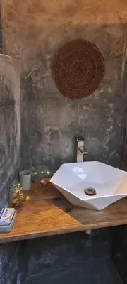 a bathroom sink sitting on a wooden table at Casita de Madera Encuentro in Bombita