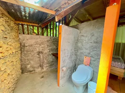 a bathroom with a blue toilet in a room at Casita de Madera Encuentro in Bombita