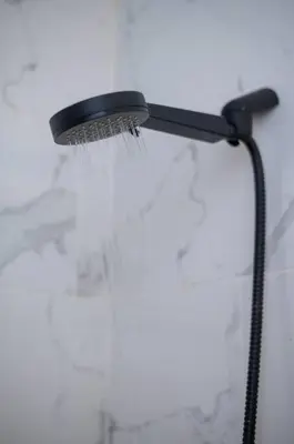 a black shower head with water on it at Cozy Suite 8 en la Zona Colonial in Santo Domingo