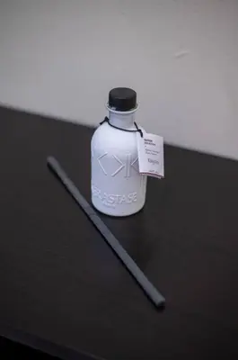 a bottle and two sticks on a table at Cozy Suite 8 en la Zona Colonial in Santo Domingo