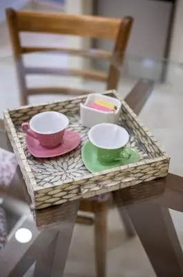 a small table with two cups and plates on it at Cozy Suite 8 en la Zona Colonial in Santo Domingo