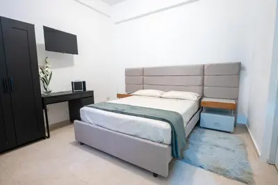 a bedroom with a large bed and a television at Estudio 9 en la Zona Colonial in Santo Domingo