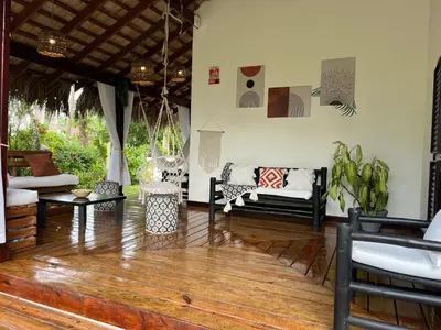 a living room with furniture and a wooden floor at Playa Bonita 4 minute walk from our private Villa Anantara Bonita in Las Terrenas