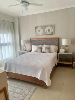 a bedroom with a large bed with two night stands at Bello apartamento en Evaristo Morales, 1 BR in Santo Domingo