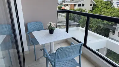 a balcony with a table and chairs on a balcony at Bello apartamento en Evaristo Morales, 1 BR in Santo Domingo