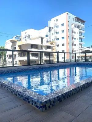 a large swimming pool in front of a building at Bello apartamento en Evaristo Morales, 1 BR in Santo Domingo