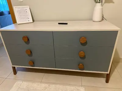 a blue dresser with wooden knobs on it at Bello apartamento en Evaristo Morales, 1 BR in Santo Domingo