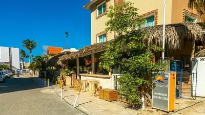 a restaurant with tables and chairs on a street at Private Pool View 2BDR in Los Corales Punta Cana in Punta Cana