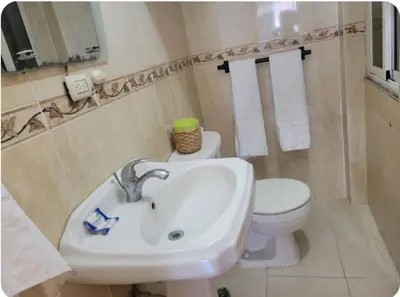 a bathroom with a sink and a toilet at Amplio apartmento in Santo Domingo