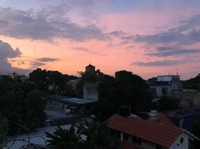 a sunset over a city with trees and buildings at Centerpice Colonial Zone in Santo Domingo