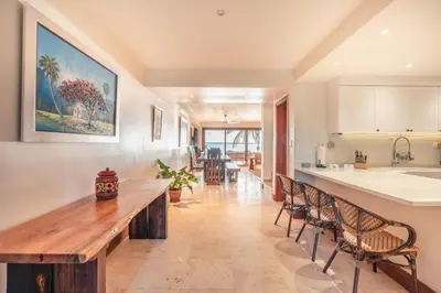 a kitchen with a long wooden table and chairs at Magnificent Villa at Puerto Bahia in Sabana