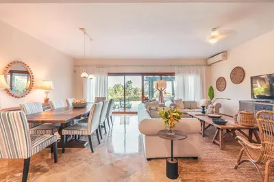 a dining room and living room with a table and chairs at Magnificent Villa at Puerto Bahia in Sabana