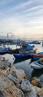 a group of boats are docked in the water at Margarita in Río San Juan