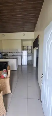 a kitchen with white appliances and a white tile floor at Margarita in Río San Juan