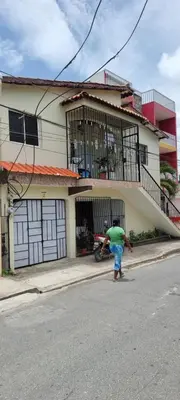 a man riding a skateboard down a street in front of a house at Margarita in Río San Juan
