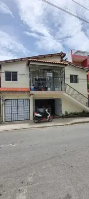 a motorcycle parked in front of a house at Margarita in Río San Juan