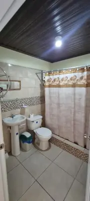 a bathroom with a toilet and a sink at Margarita in Río San Juan