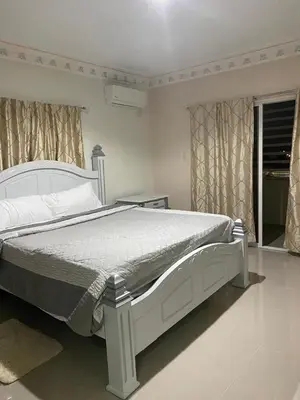 a bedroom with a large white bed in a room at Pen House Vista Sur in Baní