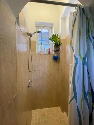 a bathroom with a shower with a shower curtain at Centrico ciudad colonial in Santo Domingo