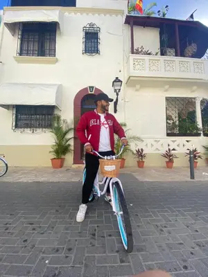 a man sitting on a bike with a basket at Studio 27 Colonial, Centro Histórico in Santo Domingo