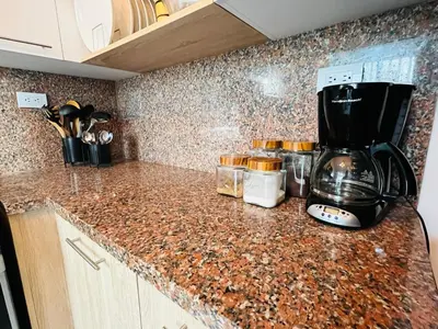 a kitchen counter with a coffee maker on it at Beautiful Condo in La Romana with pool near Caleta Beach in La Romana