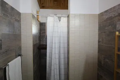 a bathroom with a shower with a white shower curtain at Paraiso Bayahibe by Mireya in Bayahibe