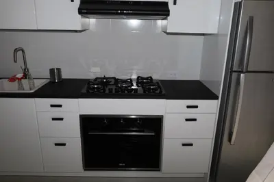 a kitchen with a black stove and a refrigerator at Paraiso Bayahibe by Mireya in Bayahibe