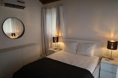 a bedroom with a bed with a mirror and two lamps at Paraiso Bayahibe by Mireya in Bayahibe