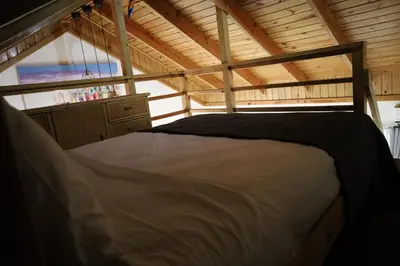 a large bed in a room with a wooden ceiling at Paraiso Bayahibe by Mireya in Bayahibe