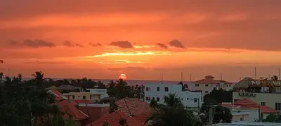 a sunset over a city with the ocean and buildings at Venere Bayahibe by Mireya in Bayahibe