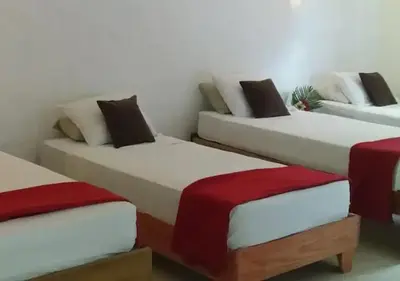 three beds are lined up in a room at Propiedad de alto standing con vista al mar, piscina, tenis, hasta 12 personas in Las Terrenas
