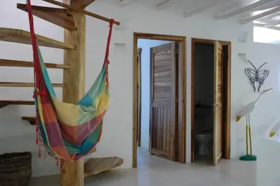 a colorful hammock in a room with a bathroom at Propiedad de alto standing con vista al mar, piscina, tenis, hasta 12 personas in Las Terrenas
