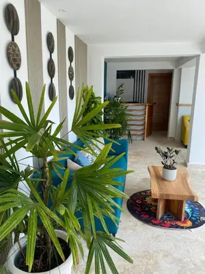 a living room with potted plants and a table at Samaná Suites Hotel by Habita in Santa Bárbara de Samaná