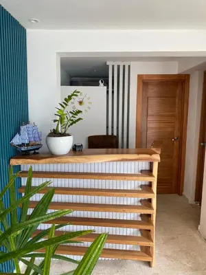 a room with a table with a potted plant on it at Samaná Suites Hotel by Habita in Santa Bárbara de Samaná