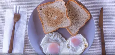 a plate with eggs and toast on a table at Samaná Suites Hotel by Habita in Santa Bárbara de Samaná
