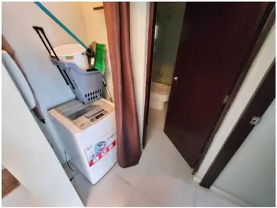 a room with a refrigerator next to a door at Lincoln Suite Pool - Gym - Sauna in Santo Domingo