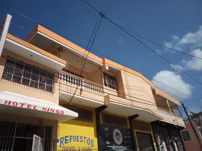 a building with a hotel kingso sign in front of it at Hotel Ningo in Santa Bárbara de Samaná