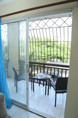 a room with a balcony with a table and chairs at Apto CALETA BEACH 3HAB in La Romana