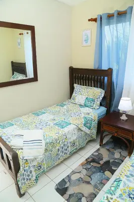 a bedroom with two beds and a mirror and a table at Apto CALETA BEACH 3HAB in La Romana