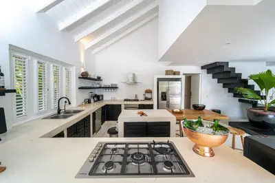 a kitchen with a sink and a stove top oven at Casa Panamera- 5br luxury beach Villa Playa Coson in Las Terrenas