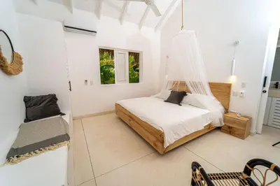 a bedroom with a bed with a hammock in it at Casa Panamera- 5br luxury beach Villa Playa Coson in Las Terrenas