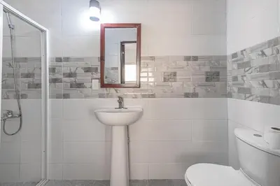 a bathroom with a sink and a toilet and a mirror at Spacious 2Br 2Bath Apartment Terrace & Street View in La Viva