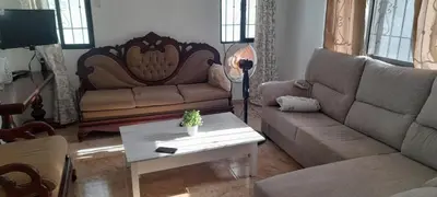 a living room with two couches and a coffee table at Villa Isabel, NO SMOKING, cerca embajada USA in Santo Domingo