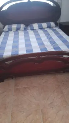a bed with a blue and white checkered mattress at Villa Isabel, NO SMOKING, cerca embajada USA in Santo Domingo