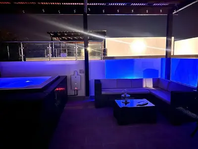 a blue room with a couch and a table at Outstanding Pent House w/Jacuzzi in Santiago de los Caballeros
