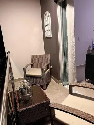 a living room with a chair and a table at Outstanding Pent House w/Jacuzzi in Santiago de los Caballeros