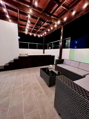 a living room with a couch and a table at Magnificent Pent House w/Jacuzzi in Santiago de los Caballeros